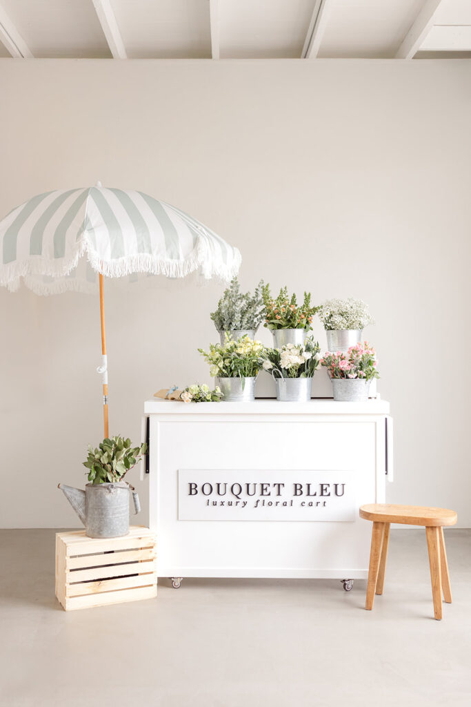 Sacramento brand photography a white cart with plants and a umbrella