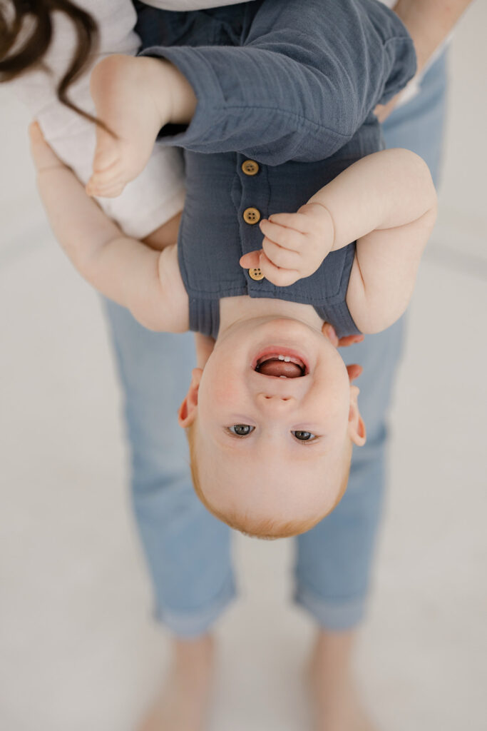 Ripon Motherhood Studio- a baby upside down in a person's arms