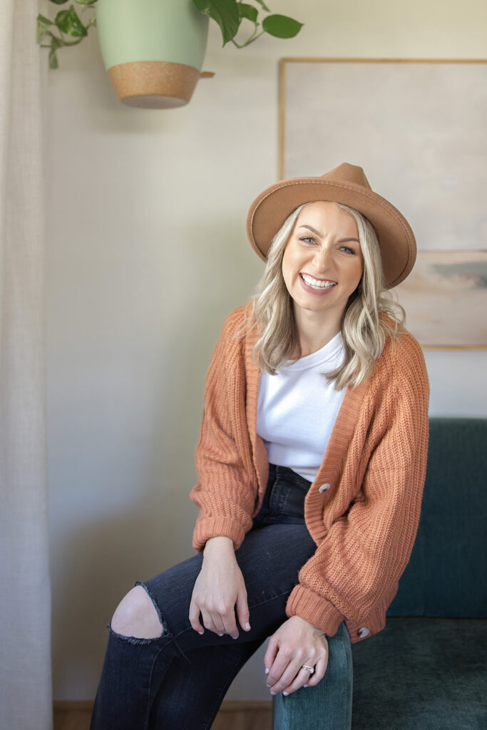 a woman wearing a hat and cardigan