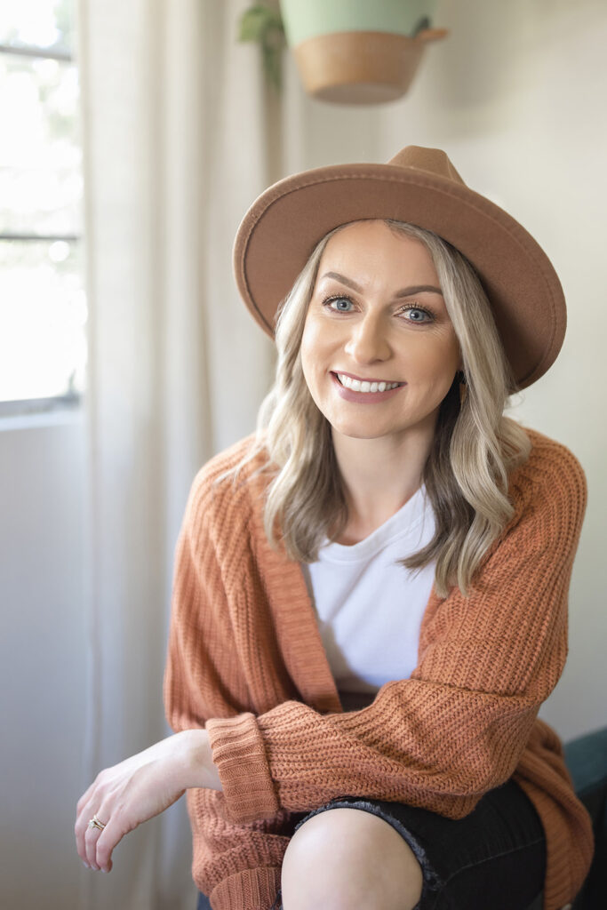 a woman wearing a hat and sweater
