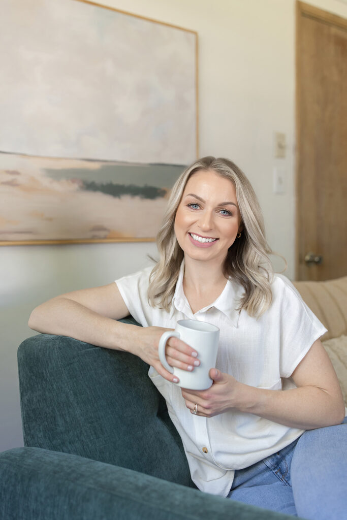 a woman holding a white mug