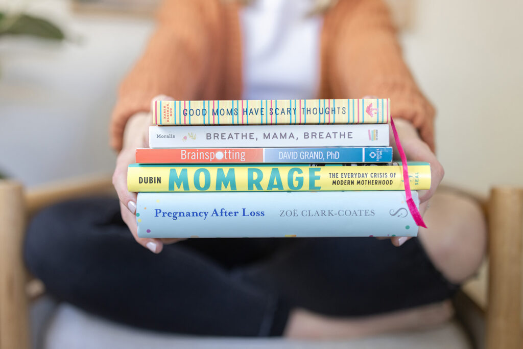 a person holding a stack of books