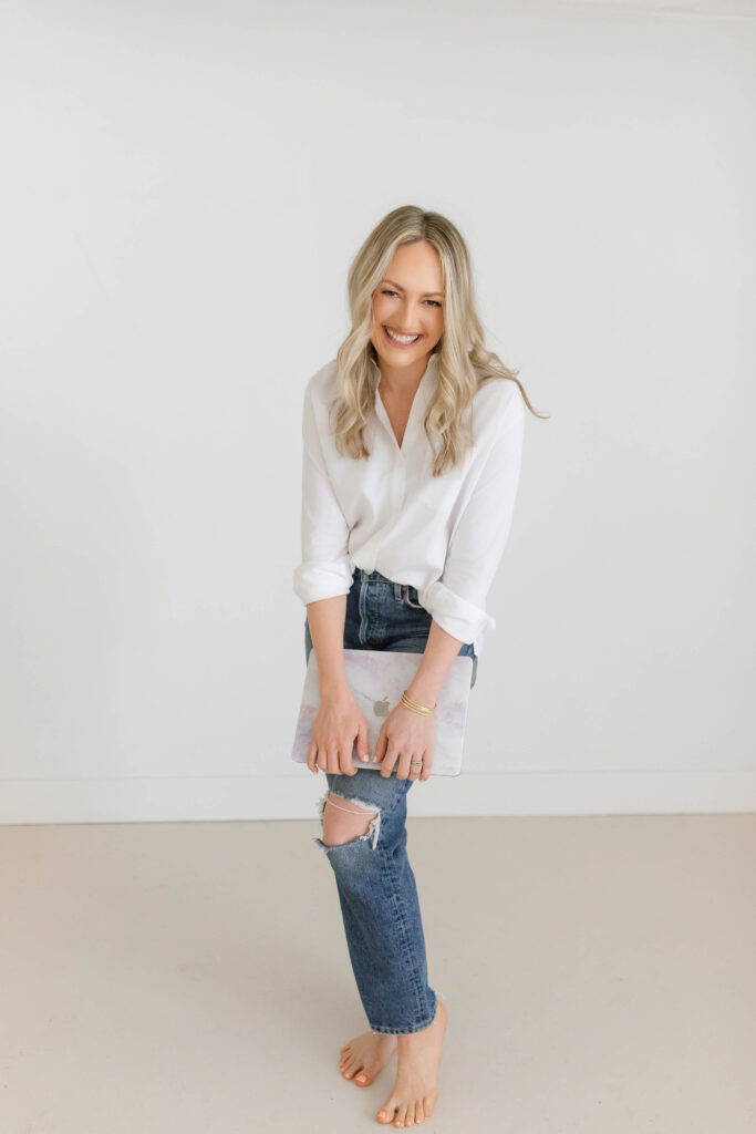 Professional headshot of Sacramento branding photographer Nicole Hodgson smiling with camera