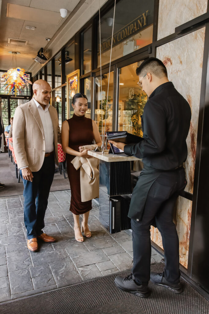 A cozy and welcoming view of the restaurant's dining space filled with happy guests.