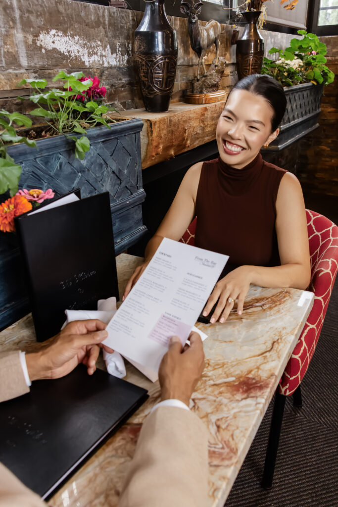A cozy and welcoming view of the restaurant's dining space filled with happy guests.