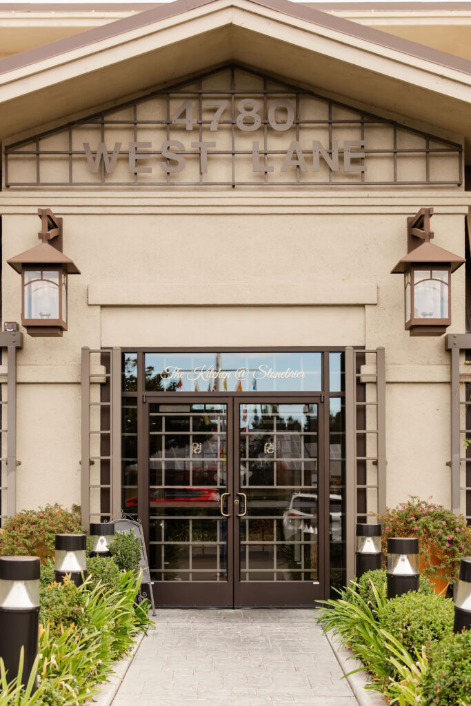 Exterior view of The Kitchen at StoneBrier restaurant with warm lighting at dusk