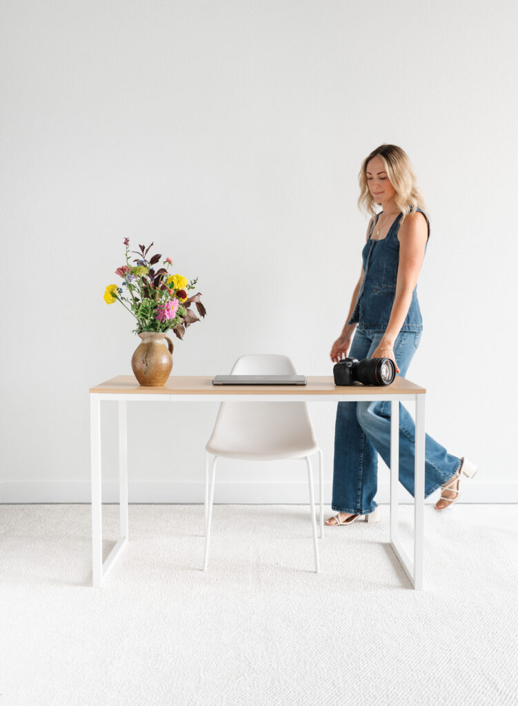 Minimalist desk with flowers and camera