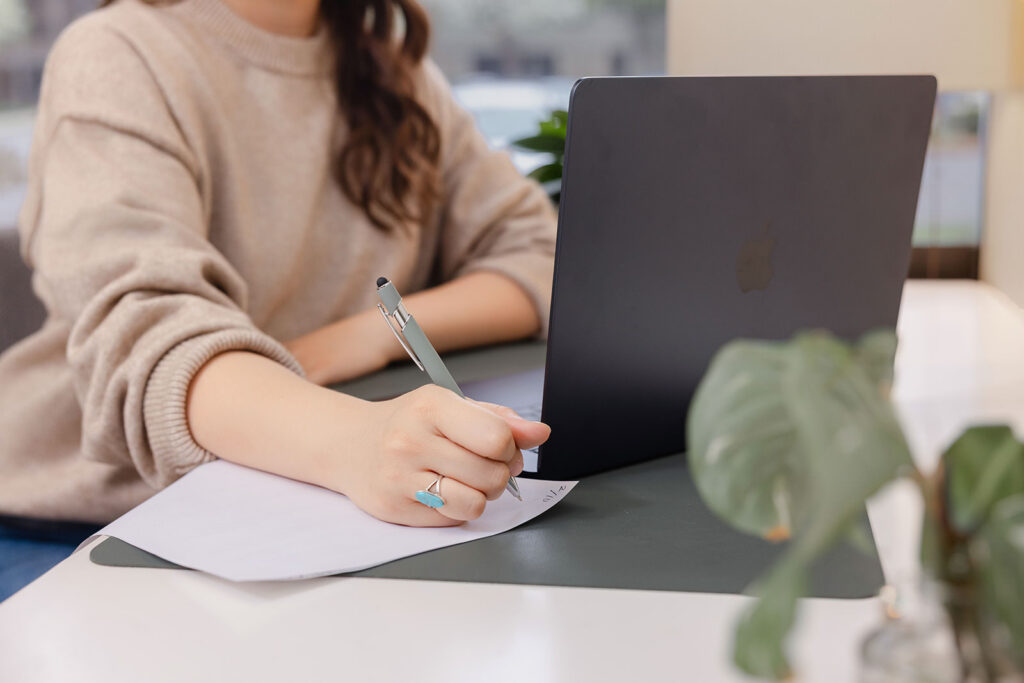 Sacramento LMFT working at laptop — brand photography and headshots for therapists in private practice