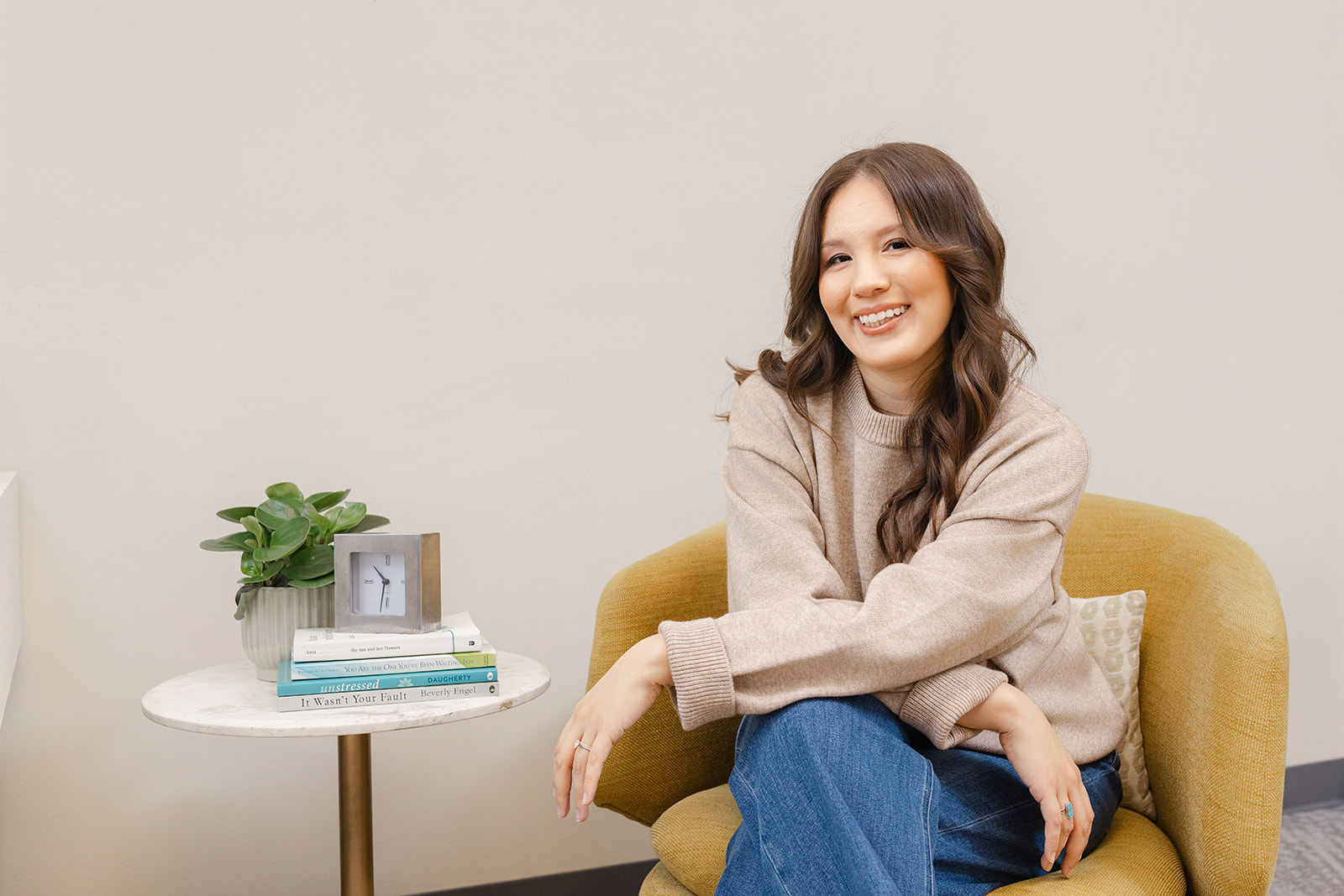 Sacramento therapist Marisa Ronquillo LMFT seated in her office — brand photography for mental health professionals
