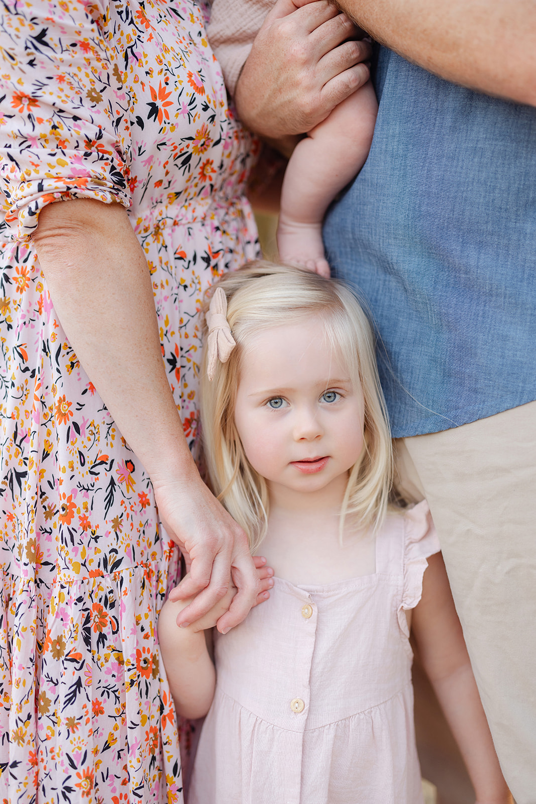 toddler girl in pink dress styled for family photography session