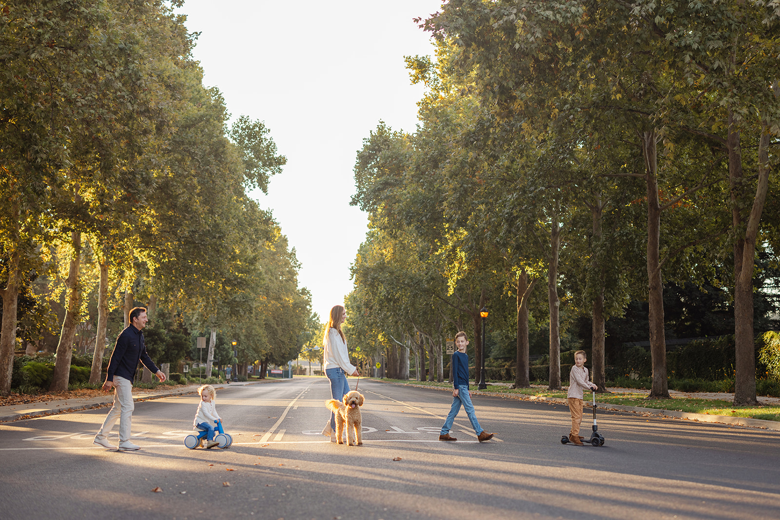 family walking across crosswalk during family photograph session